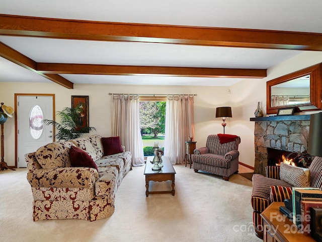 living room with carpet, beamed ceiling, and a stone fireplace