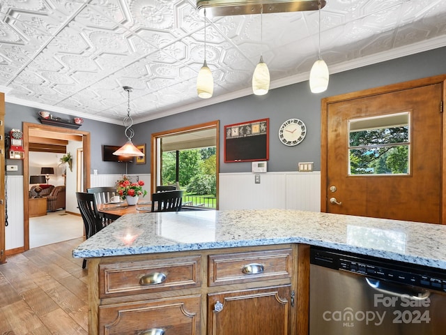 kitchen with light stone countertops, light hardwood / wood-style flooring, stainless steel dishwasher, hanging light fixtures, and ornamental molding