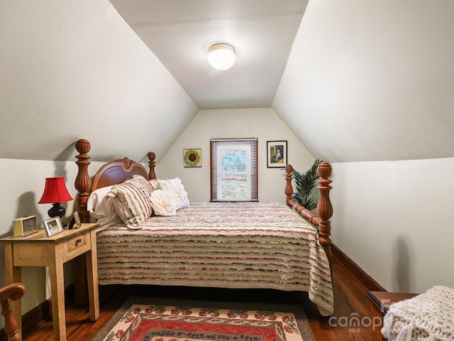 bedroom featuring vaulted ceiling and dark hardwood / wood-style floors