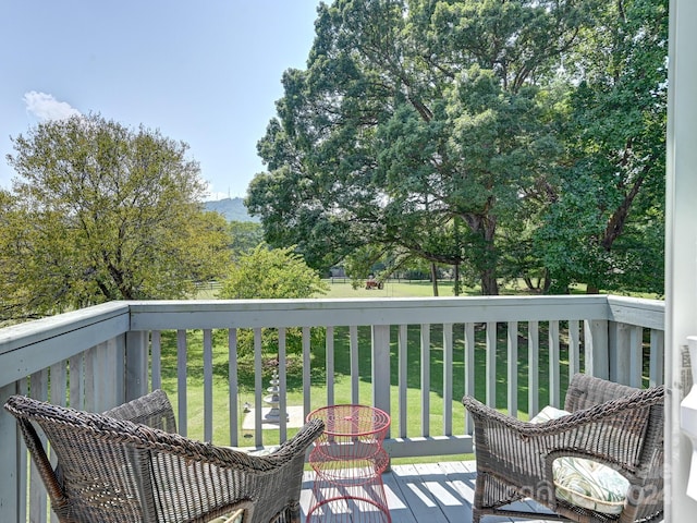 wooden terrace with a yard