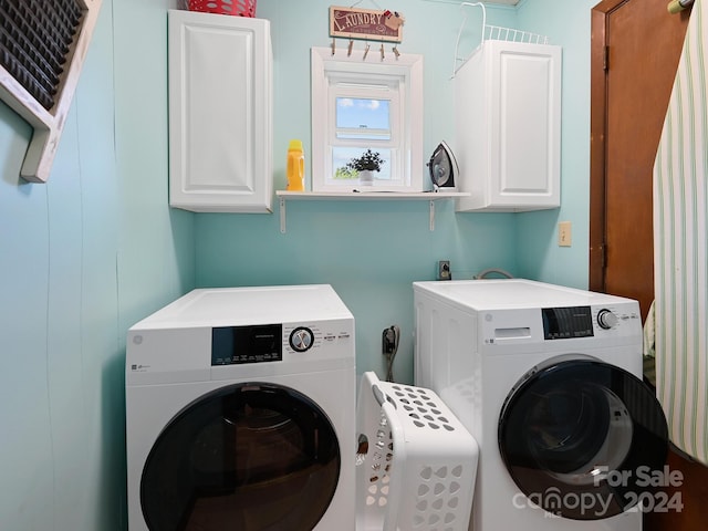 laundry room featuring cabinets and separate washer and dryer