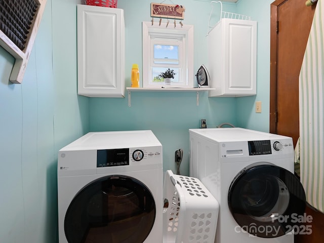 laundry room with separate washer and dryer and cabinet space