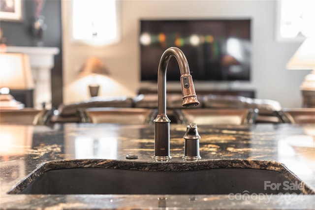 room details featuring sink and dark stone counters