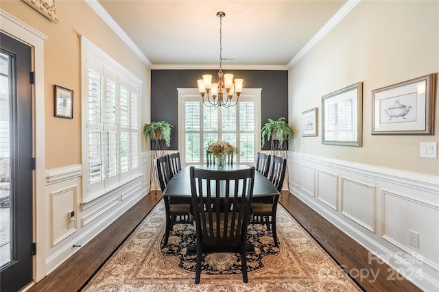 dining room with a notable chandelier, ornamental molding, and hardwood / wood-style flooring