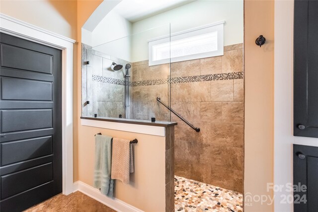 bathroom featuring a tile shower and tile patterned floors