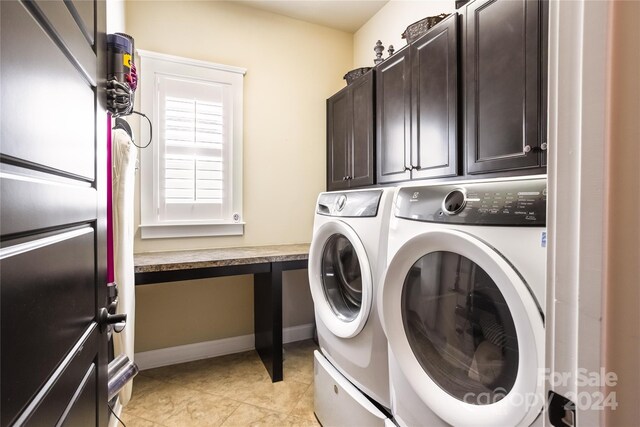 laundry room featuring light tile patterned floors, washing machine and dryer, and cabinets