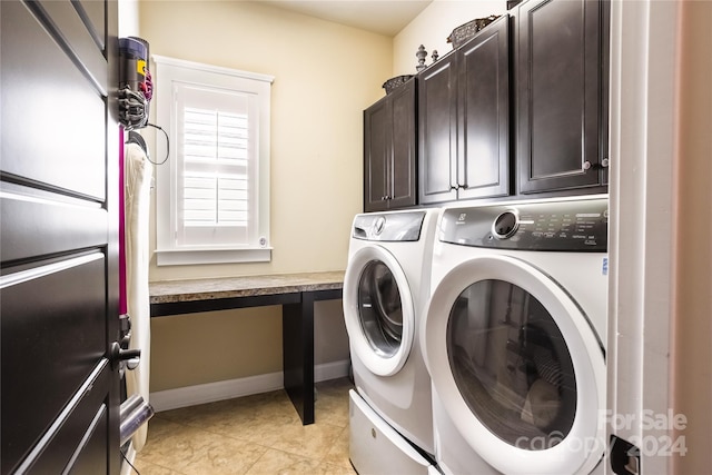 laundry room featuring light tile patterned floors, independent washer and dryer, cabinet space, and baseboards