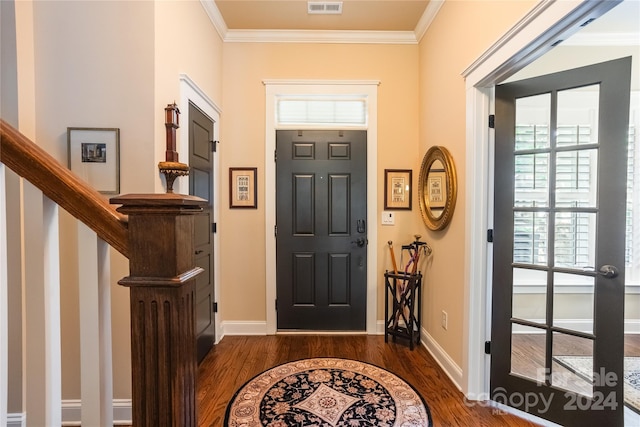 foyer featuring plenty of natural light, crown molding, and wood-type flooring