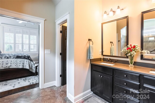 bathroom featuring a wealth of natural light, vanity, and tile patterned floors