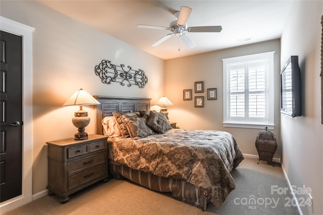 bedroom featuring ceiling fan and light carpet