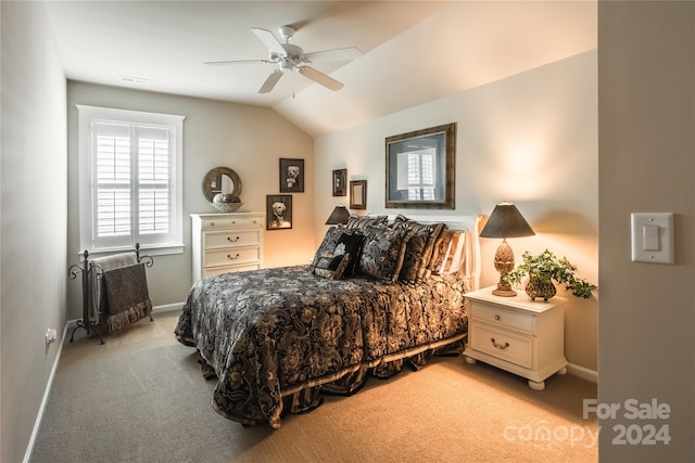 carpeted bedroom with ceiling fan and vaulted ceiling