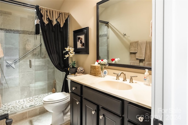 bathroom with a shower stall, toilet, and vanity