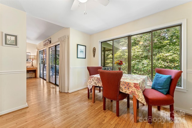 dining space with ceiling fan and light hardwood / wood-style floors