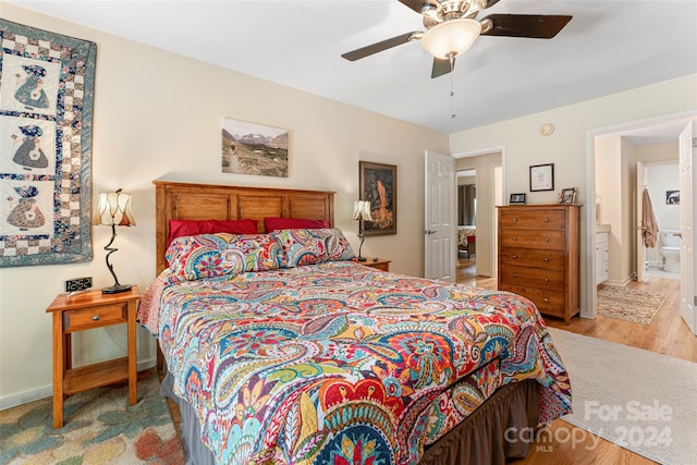 bedroom with ceiling fan, light hardwood / wood-style flooring, and ensuite bathroom