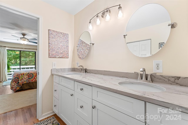 bathroom with ceiling fan, dual bowl vanity, and hardwood / wood-style floors