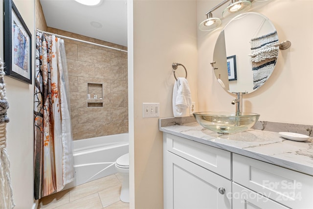 full bathroom featuring shower / tub combo, vanity, toilet, and tile patterned flooring