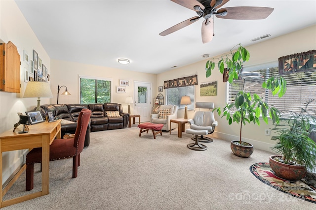 living room featuring ceiling fan and carpet