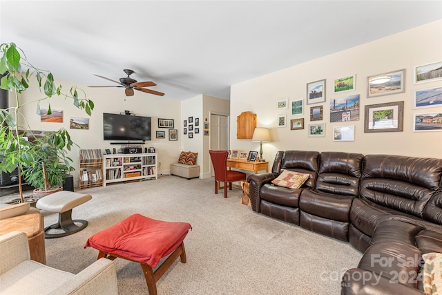 living room featuring ceiling fan and carpet