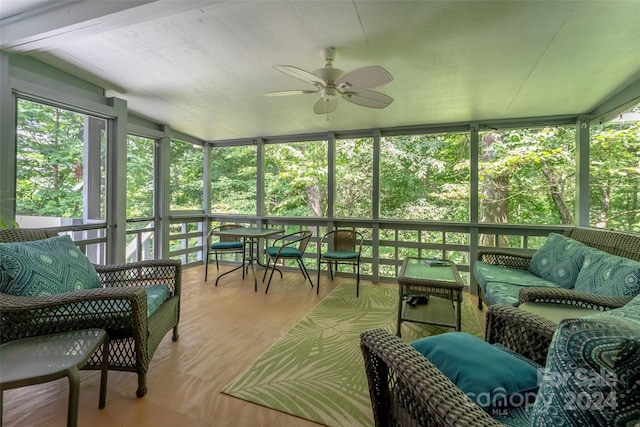 sunroom featuring ceiling fan and vaulted ceiling