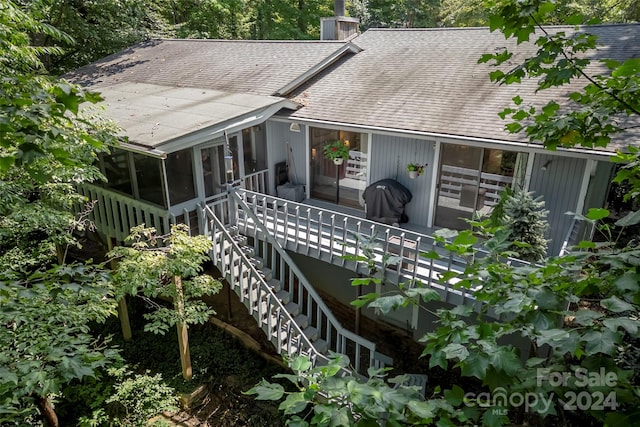 back of property with a sunroom