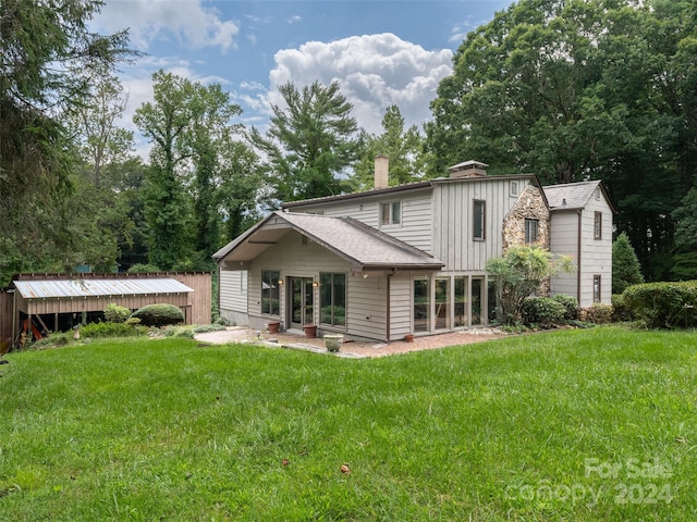 back of property featuring a lawn