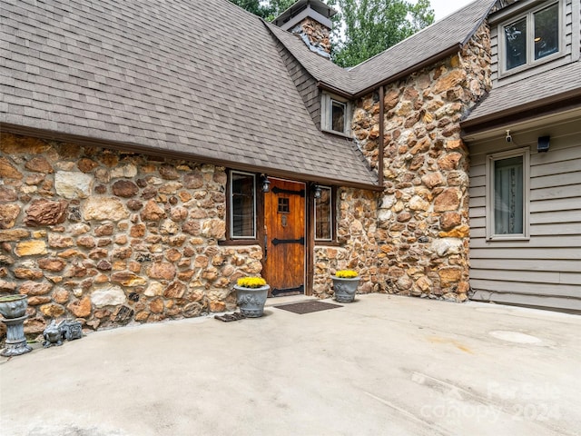 127 Springside Rd, Asheville, NC 28803 - doorway to property with stone siding, a patio, and roof with shingles
