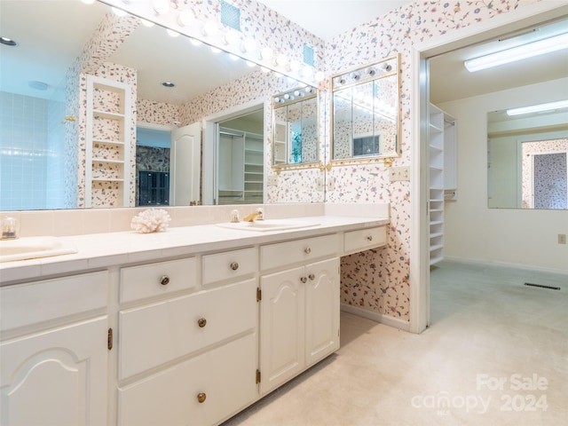 127 Springside Rd, Asheville, NC 28803 - bathroom featuring wallpapered walls, a walk in closet, and a sink