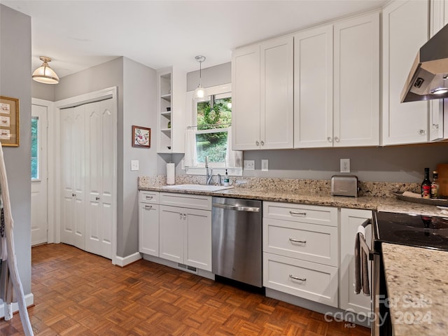 kitchen with dark parquet floors, stainless steel dishwasher, white cabinets, sink, and wall chimney exhaust hood