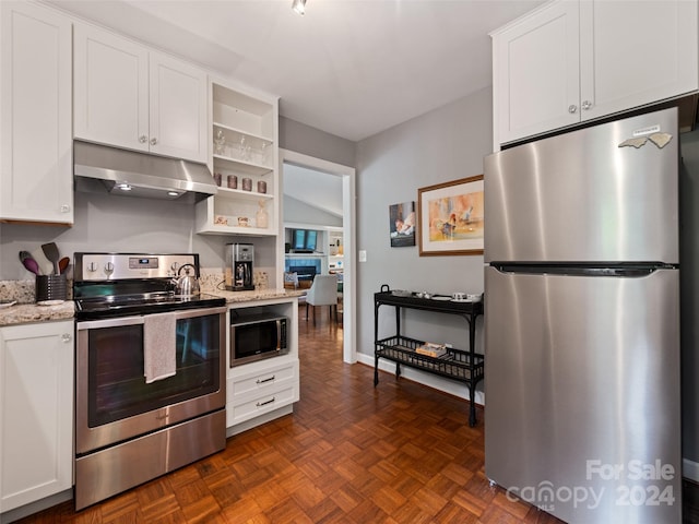 kitchen featuring dark parquet floors, white cabinets, stainless steel appliances, and light stone countertops