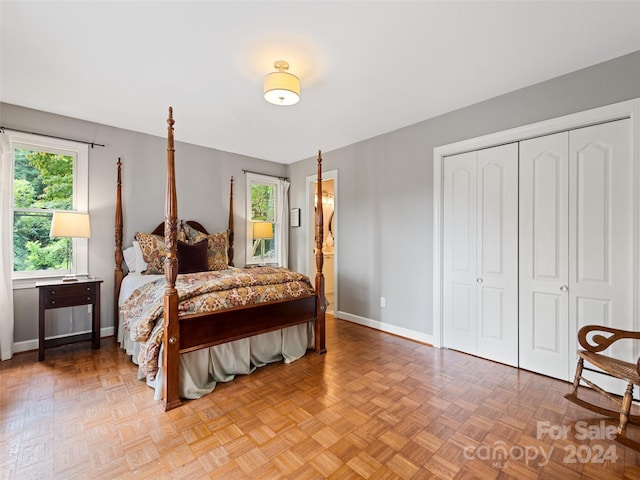 bedroom with parquet flooring and a closet