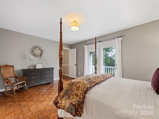 bedroom featuring parquet flooring and access to exterior