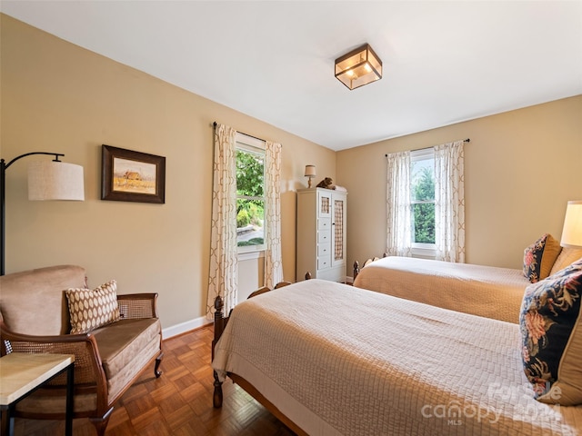 bedroom with dark parquet flooring