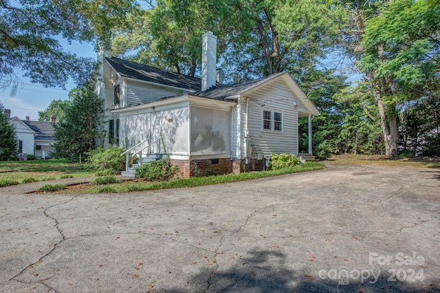 exterior space featuring entry steps, crawl space, and a chimney