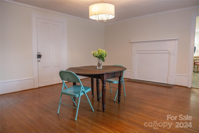 dining room with crown molding and wood finished floors