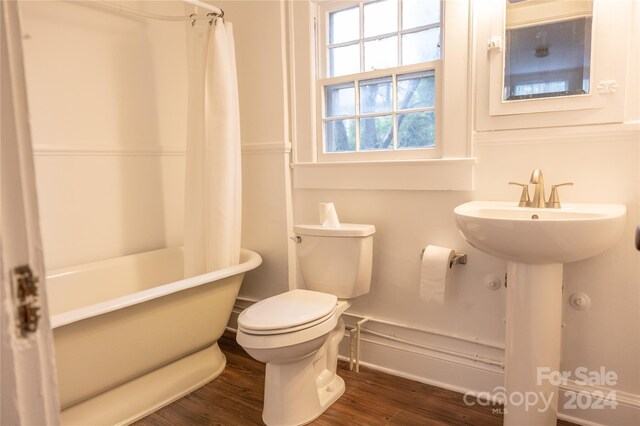 full bathroom featuring toilet and wood finished floors