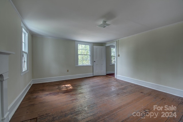 interior space featuring baseboards, dark wood-type flooring, and ornamental molding