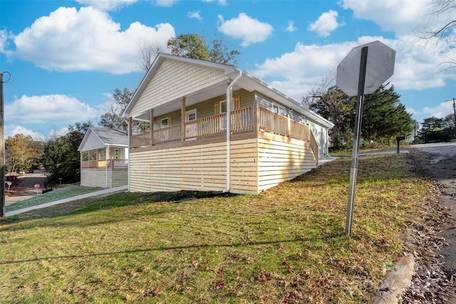 view of side of property with a lawn