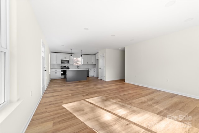 unfurnished living room with light wood-type flooring