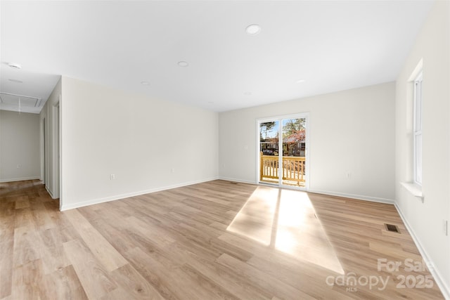 empty room with light hardwood / wood-style floors