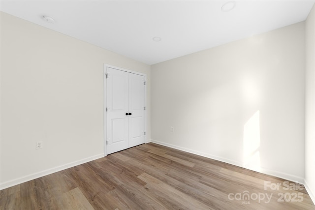 empty room with light hardwood / wood-style flooring