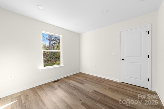 spare room featuring light hardwood / wood-style flooring