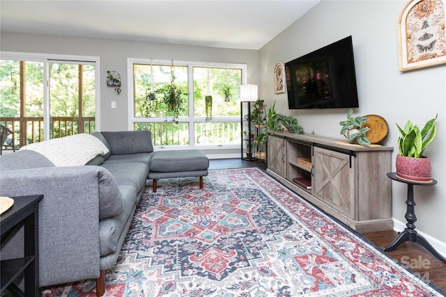 living room featuring dark wood-style flooring and baseboards