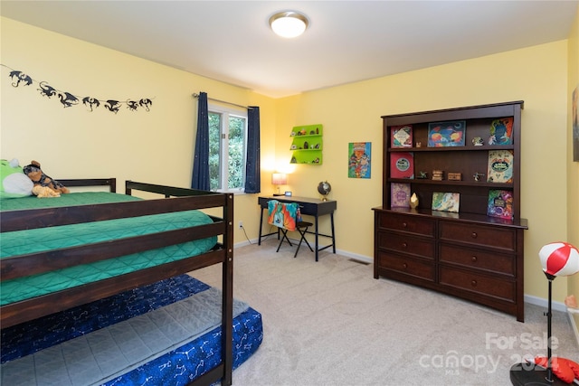 bedroom featuring baseboards and carpet flooring