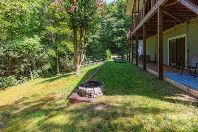 view of yard featuring fence and a fire pit