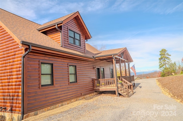 view of property exterior featuring a porch