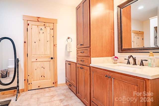 bathroom with vanity and toilet