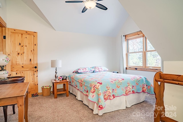 bedroom with ceiling fan, lofted ceiling, and carpet floors