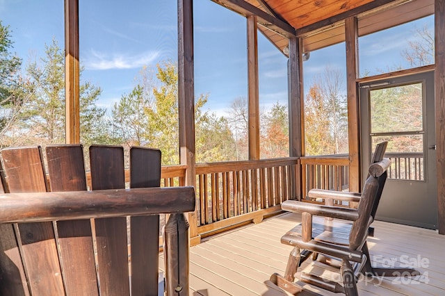 sunroom with vaulted ceiling and wooden ceiling