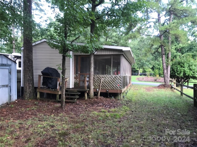 back of property with a sunroom