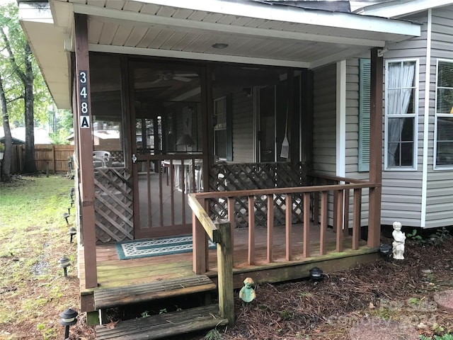 deck with a sunroom and fence